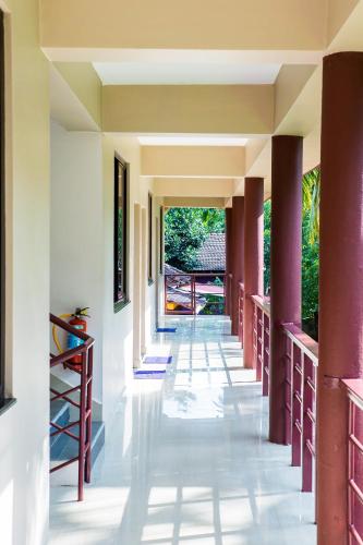 an empty hallway of a house with columns at Lazy Frog Guest House in Cavelossim