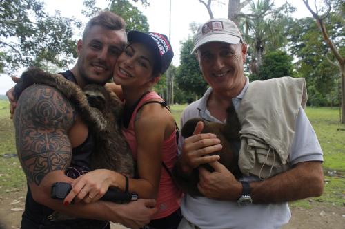 two men and a woman holding a monkey at Avatar Amazon Lodge & Canopy Park in Santa Teresa