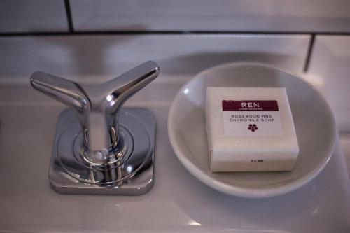 a sink with a plate with a bar of soap at Hotel Du Vin Stratford in Stratford-upon-Avon