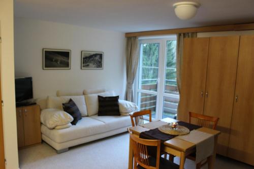 a living room with a couch and a table at Apartmány Gryf Harrachov in Harrachov