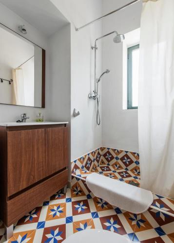 a bathroom with a sink and a mirror at La Umbría de la Ribera in El Pedroso