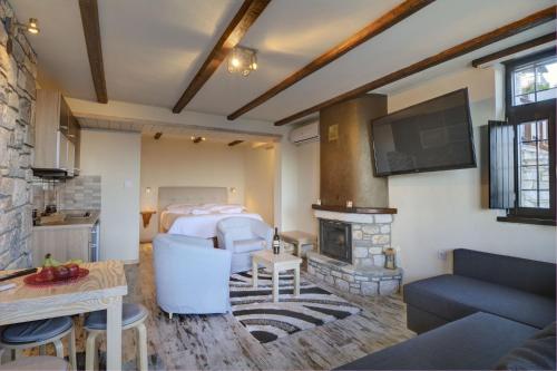 a living room with a bed and a fireplace at Mple Feggari in Mouresi