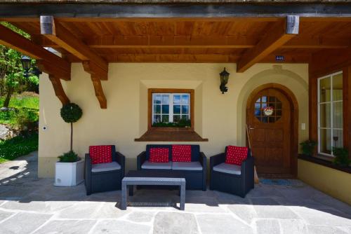 a patio with chairs and a table and a door at Apartments Villa Surlej in Davos
