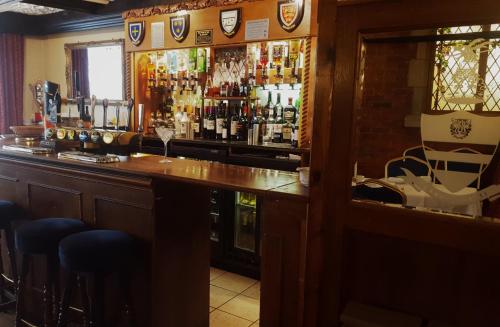 a bar with a lot of bottles of alcohol at Marygreen Manor in Brentwood