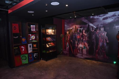 a room with a poster of the avengers on the wall at Monroe Hotel & Suites in Manama