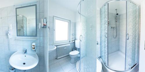 a bathroom with a sink toilet and a shower at Hotel Kallmeyer in Berlin