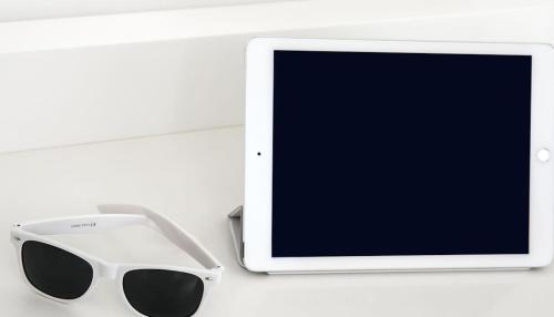 a pair of sunglasses next to a tablet computer at Casa Angelina in Praiano