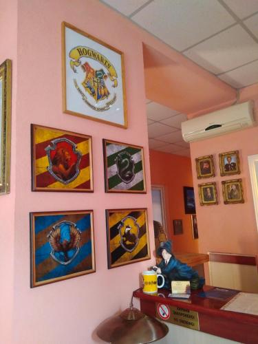 a wall with a bunch of pictures on it at У Поттера in Ternopilʼ