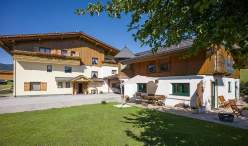 a large building with a lawn in front of it at Pension Sonnblick in Westendorf
