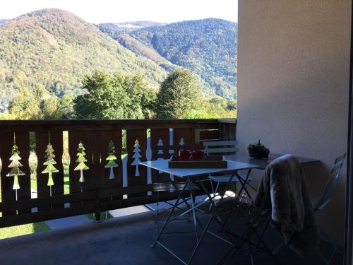 a balcony with a table and a view of mountains at Appartement Les Pics d'Aran in Luchon