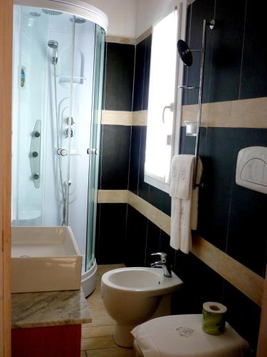a bathroom with a shower and a toilet and a sink at Costa Morroni in Levanto
