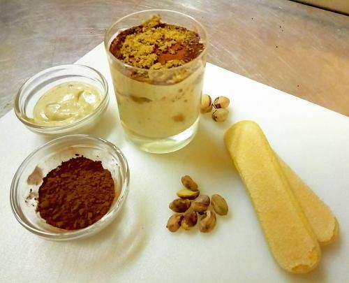 a cutting board with a drink and some nuts and bread at Hotel Blue Ribbon in Vercelli