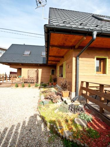 a house with a roof with a garden in front of it at Apartamenty i Domki Biały Dunajec in Biały Dunajec
