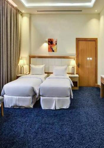 a hotel room with two beds in a room at Golden dune Hotel Services-Al Fayhaa in Riyadh