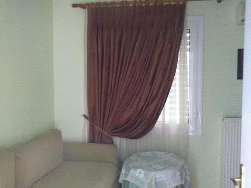a room with a window with a red curtain at Villa Castle Sea View in Paralion astros