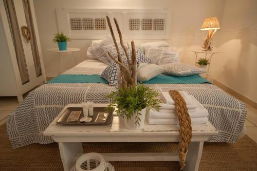 a bedroom with a bed with a table with towels at Portadamare in Trani
