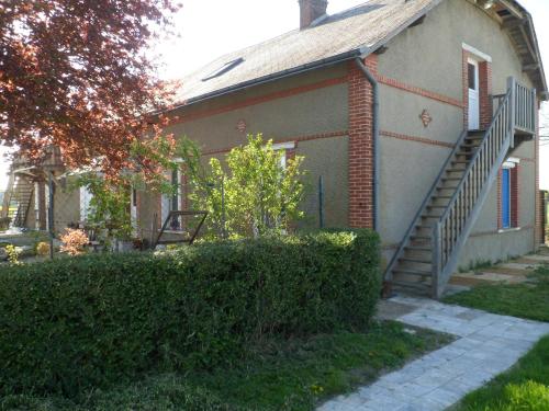 a house with a staircase on the side of it at L'etape de St Hilaire La Gravelle in Saint-Hilaire-la-Gravelle