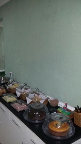 a counter top with a bunch of food on it at Hotel Tenda Brigadeiro SP in Sao Paulo