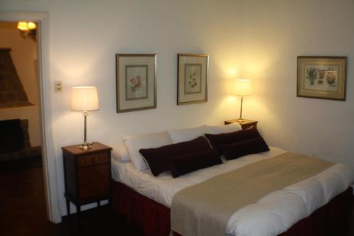 a bedroom with a large bed with two lamps at Estancia Turística San Pedro de Timote in Reboledo