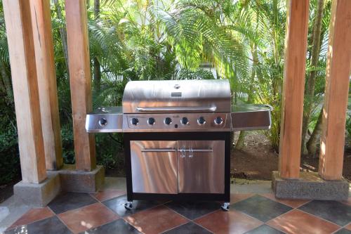 a grill sitting on top of a patio at Palm Coast Luxury Rentals in Esterillos Este