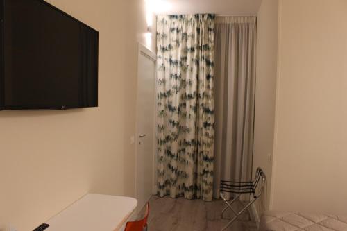TV a/nebo společenská místnost v ubytování CASA GRAMSCI B&B