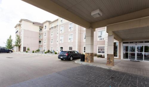 a car parked in a parking lot in front of a building at Best Western Plus South Edmonton Inn & Suites in Edmonton