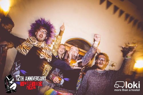 a group of people raising their hands in a party at Loki Cusco in Cusco
