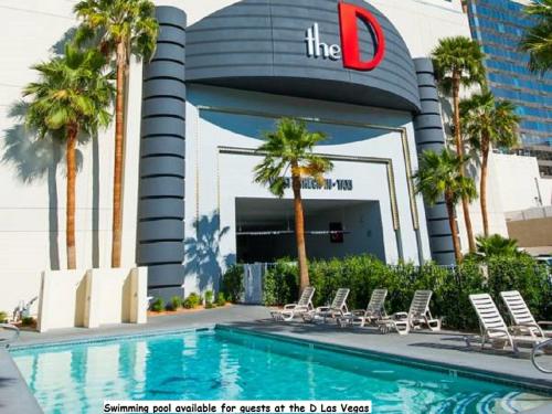 a swimming pool outside of a building with palm trees at Golden Gate Casino Hotel in Las Vegas