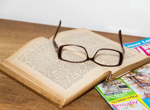 a pair of glasses sitting on top of a book at Apartment Joanneum in Graz