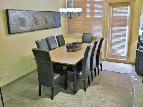 a dining room with a wooden table and chairs at Pinnacle Ridge Chalets by Fernie Lodging Co in Fernie