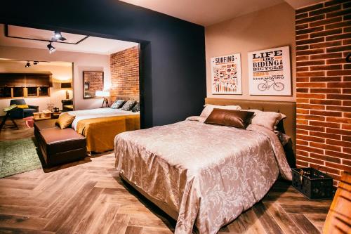a bedroom with two beds and a brick wall at Casa Azul in Lima
