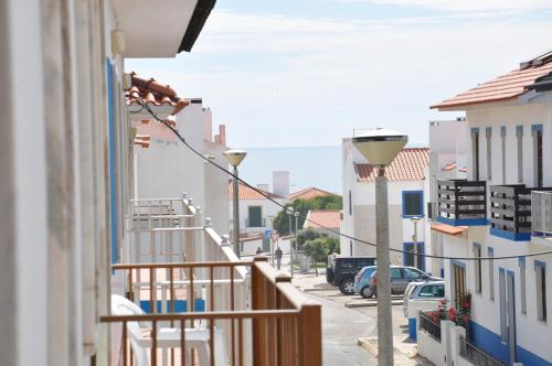 a view from a balcony of a street with buildings at Apartamentos Campos 2 in Porto Covo
