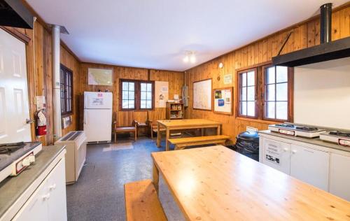 a kitchen with wooden walls and a wooden table at HI Maligne Canyon - Hostel in Jasper
