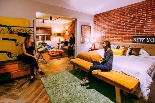 two women sitting on a bed in a room at Casa Azul in Lima