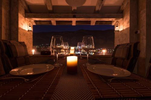 a table with wine glasses and a candle on it at Kotor old town Palace Bucha in Kotor