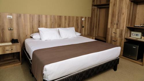 a bedroom with a large bed with wooden walls at Hotel Villa del Carmen in Arequipa
