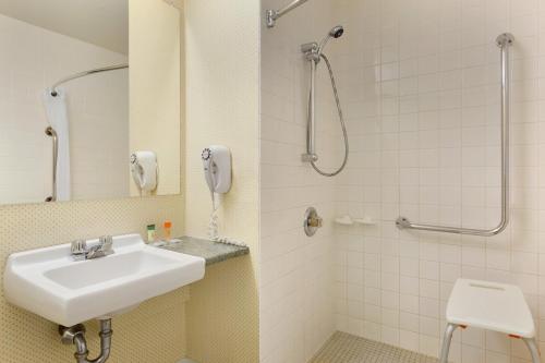 a bathroom with a sink and a shower at Travelodge by Wyndham North Bay Lakeshore in North Bay