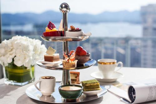 a tray of pastries on a table with cups of coffee at Huachen International Hotel in Hangzhou