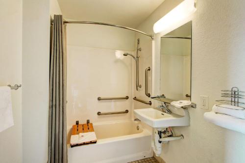 a bathroom with a sink and a bath tub at Motel 6-Denver, CO - Airport in Denver