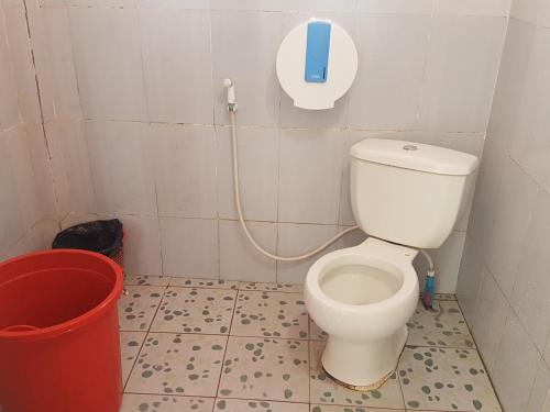 a bathroom with a toilet and a phone on the wall at Sea House Guest House in Koh Rong Island