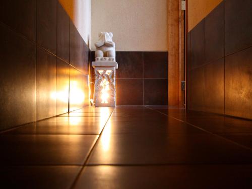 a lit up room with a candle and a statue at Kunugi Relaxation with 4 modern rooms in Hakuba