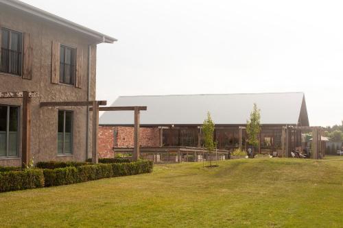 a large brick building with a lawn in front of it at The Farmhouse at Meletos in Coldstream