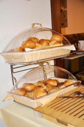 two baskets of bread sitting on top of a table at Hotel Atlantik in Borkum