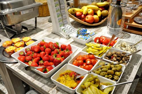 a buffet of fruits and vegetables on a table at Hotel Atlantik in Borkum