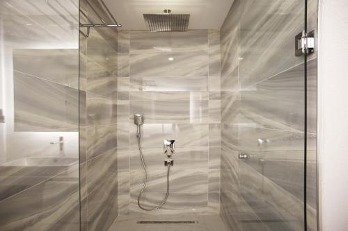 a shower with a glass door in a bathroom at Nur Beach Hotel in Kas