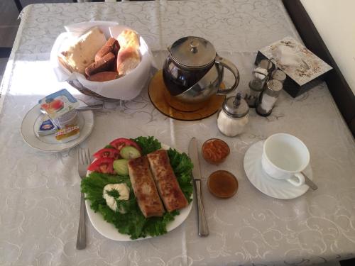 a table with a plate of food on a table at Palma Palace Hotel in Yerevan