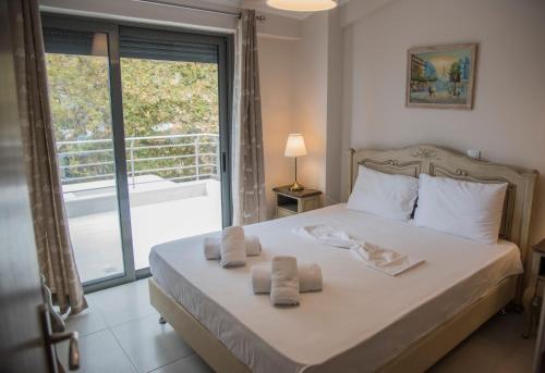 a bedroom with a bed with towels on it at Casa Christabella in Paralia Vrachou