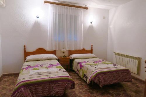 Postel nebo postele na pokoji v ubytování Hostal Jaufil