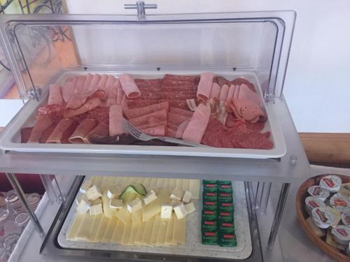 a refrigerator filled with lots of meats and cheese at Gasthaus Luggwirt in Gnesau