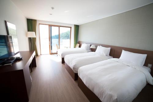 Ένα ή περισσότερα κρεβάτια σε δωμάτιο στο Dongwon Youthhostel